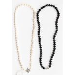 Two freshwater pearl single strand necklaces, comprising a black pearl and a white pearl necklace,