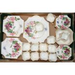 A Victorian hand painted tea set decorated with Clematis, comprising eleven cups, twelve saucers,