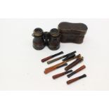 A large pair of bone field glasses, collection of various cheroot holders, including amber,