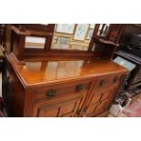 A late Victorian walnut mirror backed sideboard, the base with two drawers and two doors,