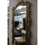 A Rococo style gilt framed oblong wall mirror,