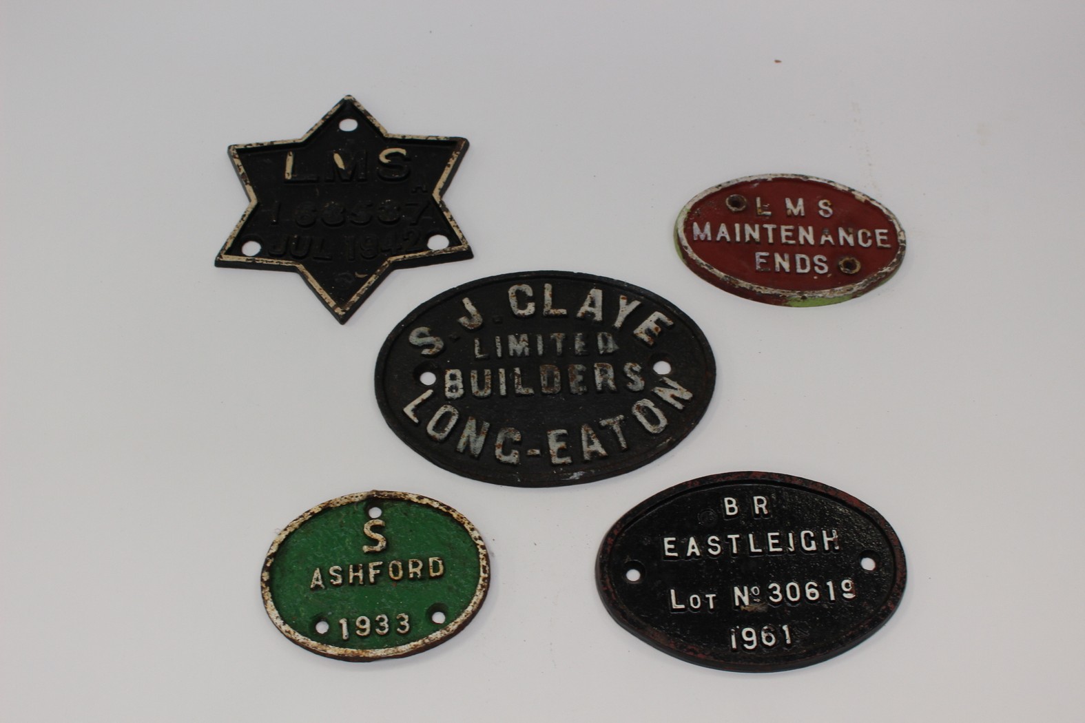 A group of five Railway cast metal plates.