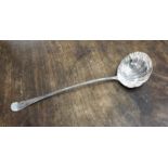 An early George III silver soup ladle Hanoverian pattern with a shell style bowl, free of initials,