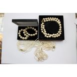 A double string of cultured faux pearls, a multi fine string of costume pearls,