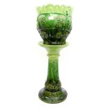 A late Victorian green glazed jardiniere and stand,
