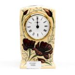 A Moorcroft mantle clock in the Chocolate Cosmos pattern, designed by Rachel Bishop,