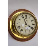 A wall mounted brass ships clock