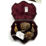 A boxed Victorian yellow metal and paste set brooch and earring set