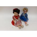 A Pedigree 22 inch doll with a Rosebud Matel 21 inch doll with a cord pull