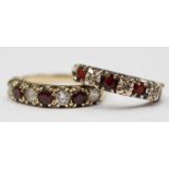 Two 9ct gold, garnet and white stone half eternity rings,