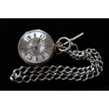 A silver keywind pocket watch on a silver watch Albert chain