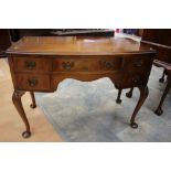 A Queen Anne style mahogany veneerer bow fronted dressing table cabriole legs
