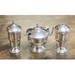 A George V silver three piece cruet of mustard, salt and pepper, maker Ernest W.