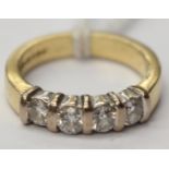An 18ct gold ring bar set with four brilliant cut diamonds.