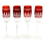 A set of four Waterford Clarendon ruby flutes, faceted stems and star cut bases,