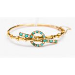 A yellow metal bracelet set with seed pearls and turquoise