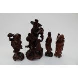 A group of four Chinese dark wood figures (Livhay; Guanyin; Shoulao;