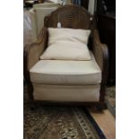An early 20th Century three piece suite, comprising three seater settee and a pair of armchairs,