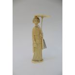 A Japanese ivory okimono of a standing Geisha holding a parasol, Meiji period (1868-1912),