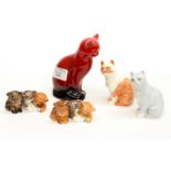 A Royal Doulton Flambe seated cat with four Royal Worcester cats and kittens,