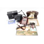 A cased Pentacon Camera, a cased pair of binoculars,