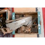 A quantity of woodworking tools, including saws, mallet, planes,