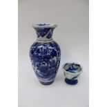 A small Japanese cup shaped vase on footed pedestal, together with a blue and white baluster vase,