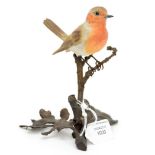 An Albany bronze and porcelain model of a Robin standing on an oak sprig