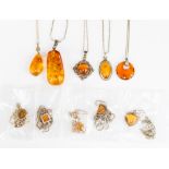 Amber pendants, many silver set with 0.