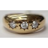 A 9ct gold ring with tapered shank set with three cubic zirconia,