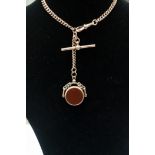 A 9ct rose gold Albert watch chain with a blood stone and carnelian fob also set in 9ct gold with a