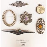 A silver locket, an amber and silver brooch,