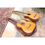 Two cased Classical guitars