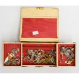 A 1950s cream leatherette jewel box and a quantity of costume jewellery, to include brooches,