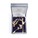 Two 9ct gold stick pins, a Stag, a Marlin, the Stag with cz stones and a leaf brooch (3) 8.