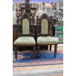 A Victorian pair of carved side chairs, circa 1870, with elaborately carved backs, turned uprights,