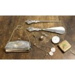 A collection of silverware, shoe horn and button hook,