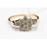 A 9ct gold diamond illusion set cluster ring, set with nine diamond chips,