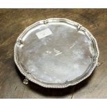 A George III silver salver, gadrooned border, on three C scroll pad feet, WC, London 1775,