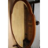 An Edwardian mahogany oval wall mirror,