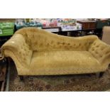 A late Victorian chaise longue, buttoned back and buttoned arms, sprung upholstered seat,