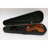 A 19th Century cased violin with bow, having single piece back,