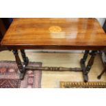 A Victorian mahogany silver table, raised on turned columns, standing on platform bases,