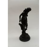 A large bronze, well modelled, of a nude female, carrying a wrap, near tree trunk,