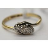 A three stone diamond ring in 18ct gold, size N, with a total gross weight 3.