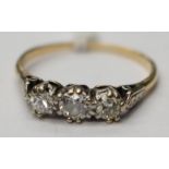 A three stone diamond ring claw set old-cut diamonds of total weight approx 0.