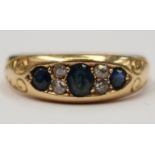 An 18ct gold ring set with three sapphires with a pair of diamonds between each stone,