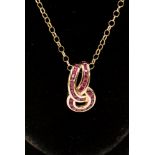 A 9ct gold chain and pendant, the pendant has channel set rubies in a twisted loop shape,
