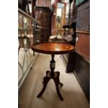 A modern yew wood veneered pedestal occasional table