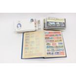 A collection of first day covers and presentation packs, with a school-boy stamp album,